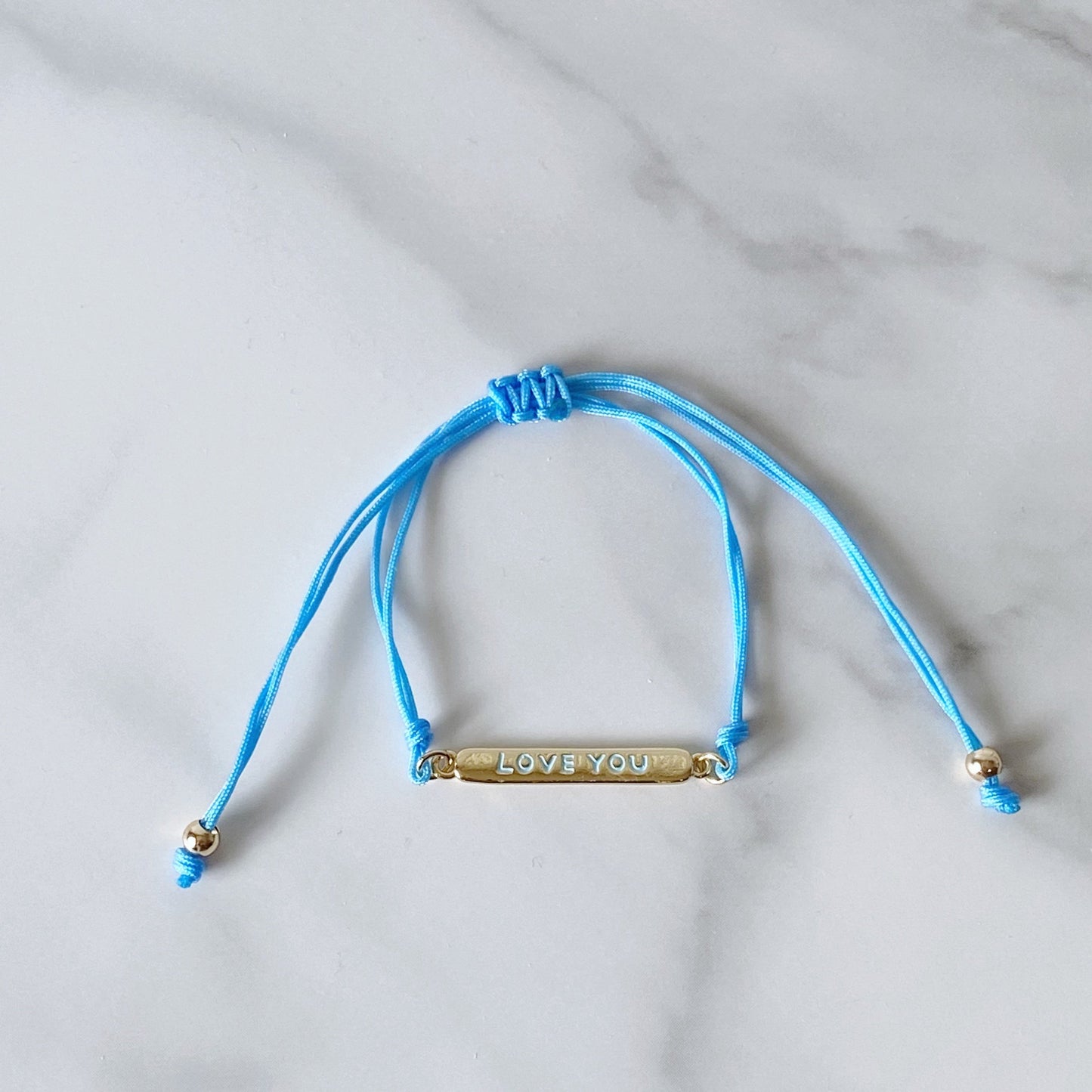 Light blue cotton cord bracelet, and "love you" gold-plated plaque, isvi boutique