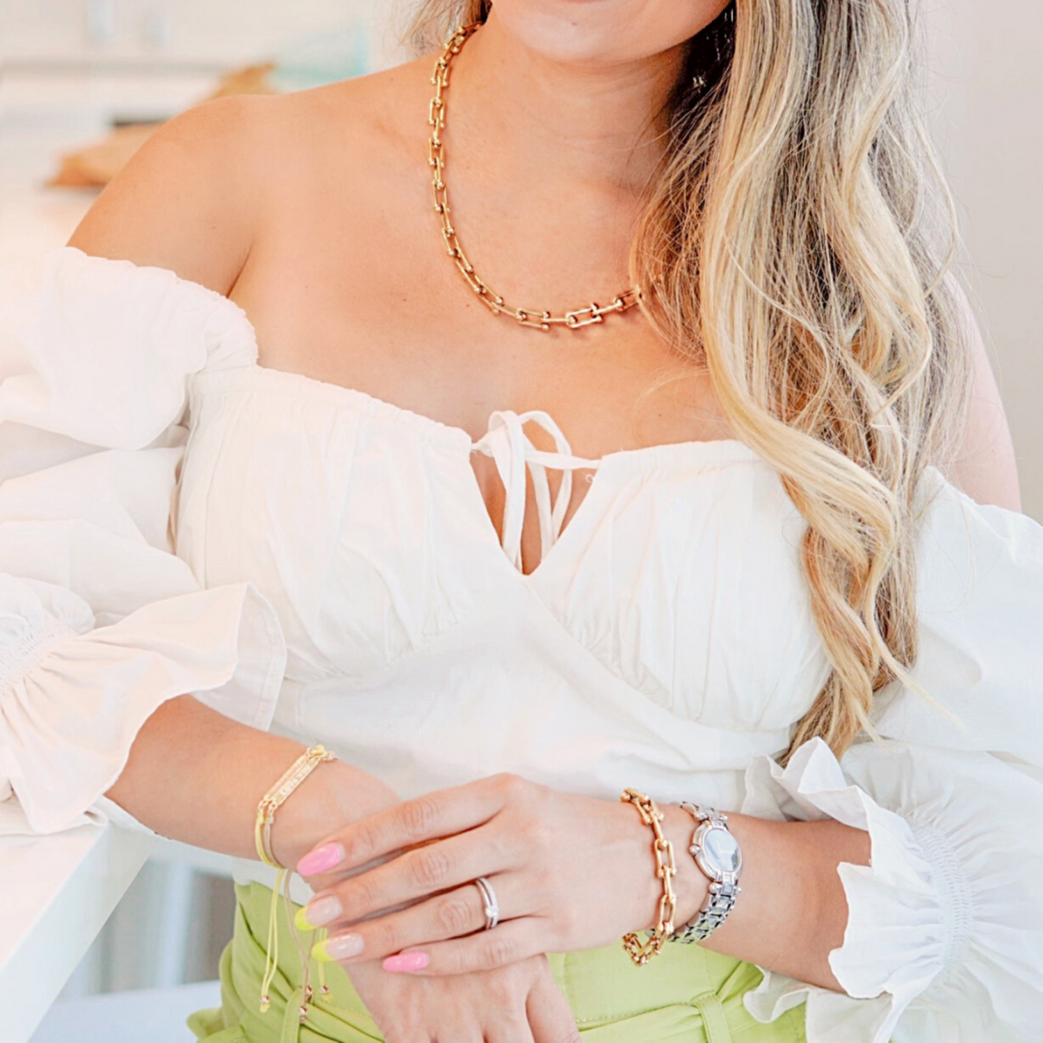 Jenni is wearing the White Bianca top accessorize with the U Link Bracelet and necklace by ISVI Boutique Miami