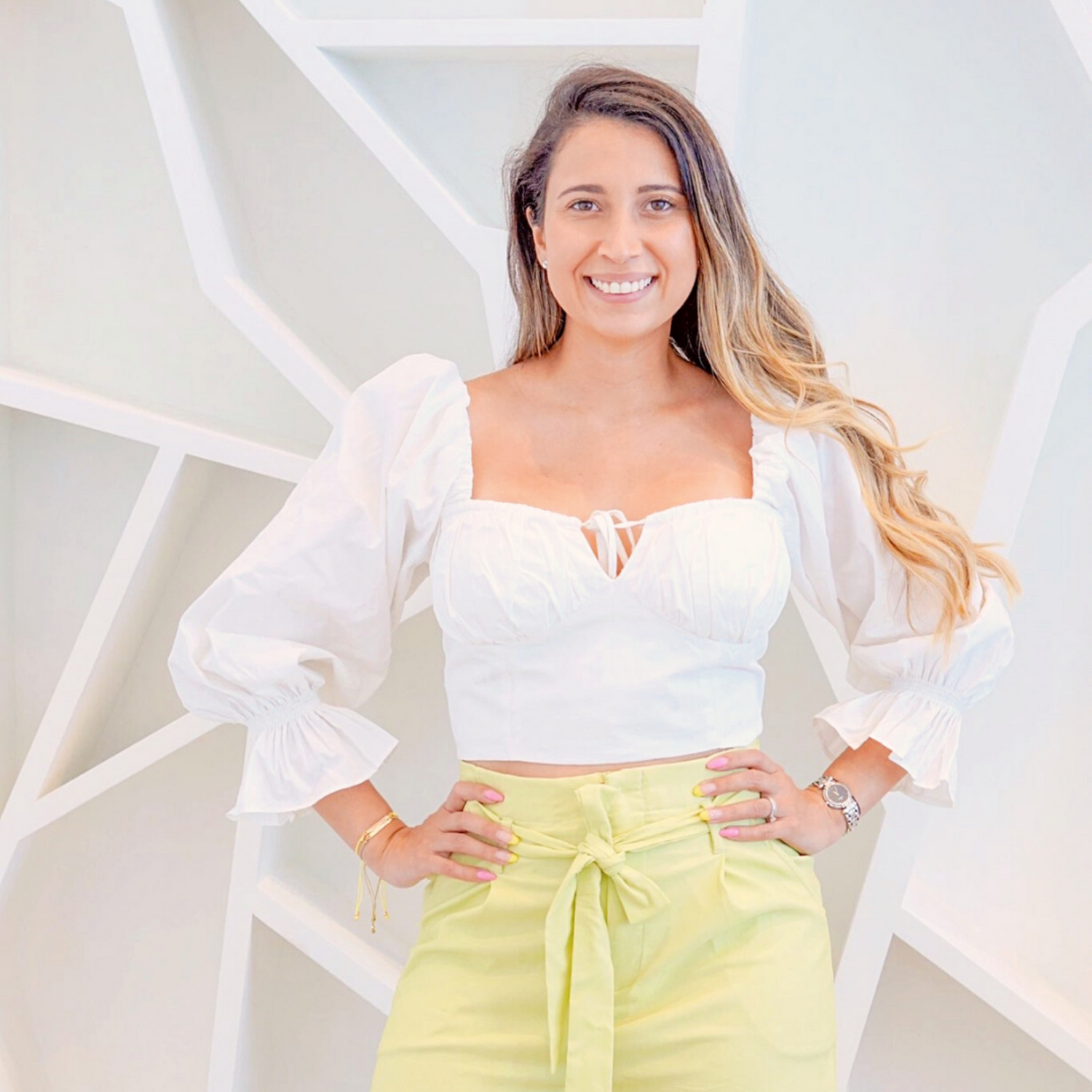 Jenni is wearing the white Bianca top and the lemon Adela shorts, by ISVI Boutique Miami