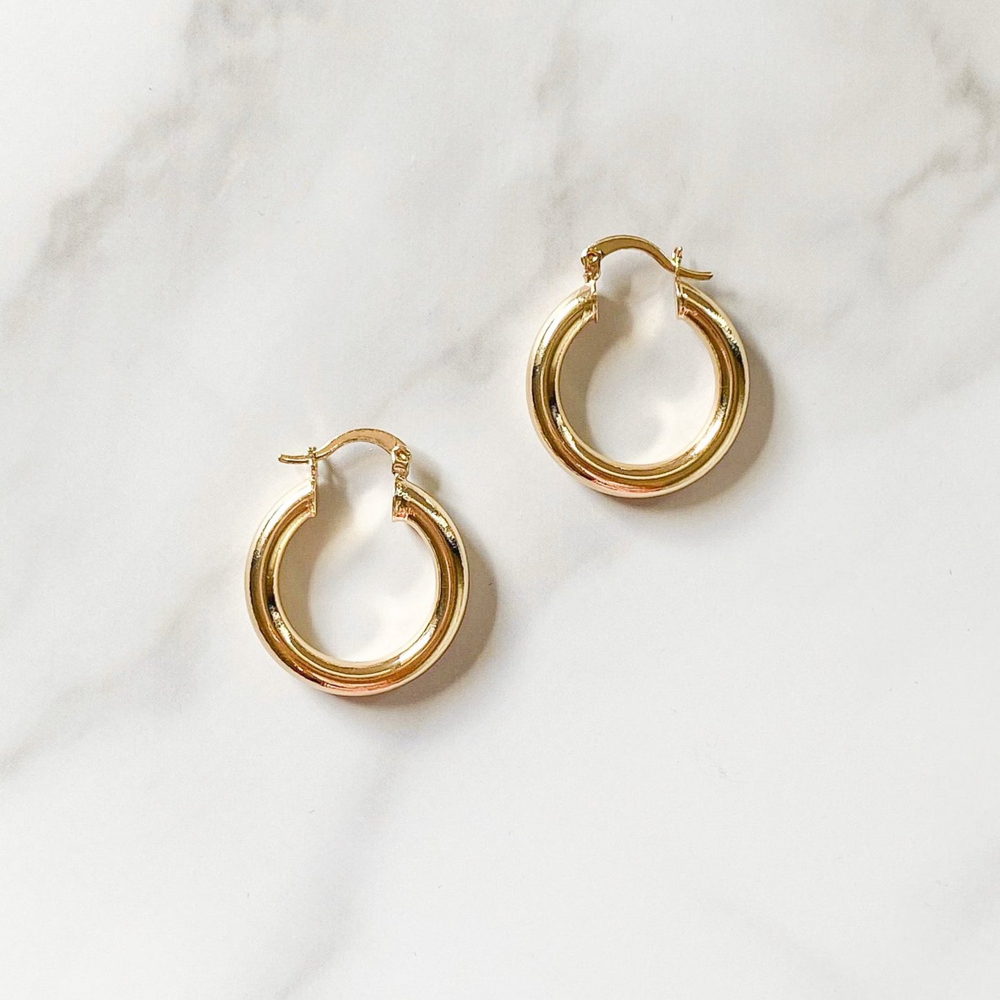 Chunky gold-filled hoops made in Brazil, hypoallergenic and water-resistant by ISVI Boutique Miami