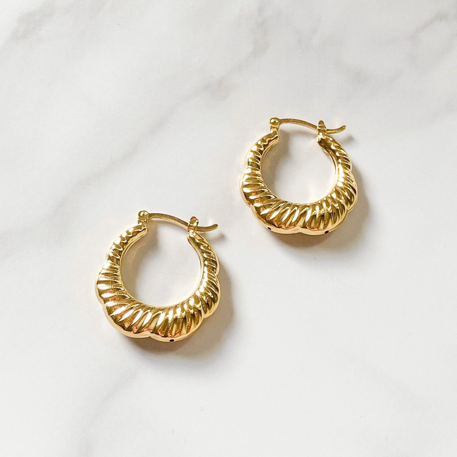 Croissant gold-filled hoops made in Brazil, hypoallergenic, water-resistants, and stylish. Sold by ISVI Boutique Miami