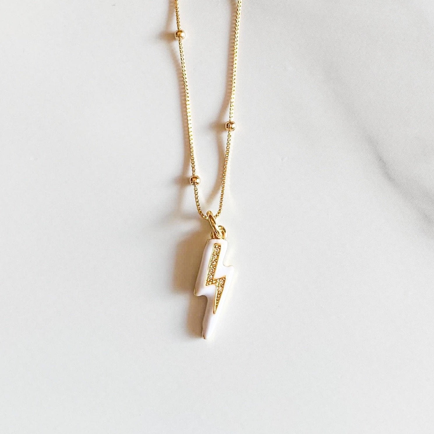 Jens lighting bold necklace, white enamel, gold-plated bold, gold-foilled necklace by ISVI Boutique Miami