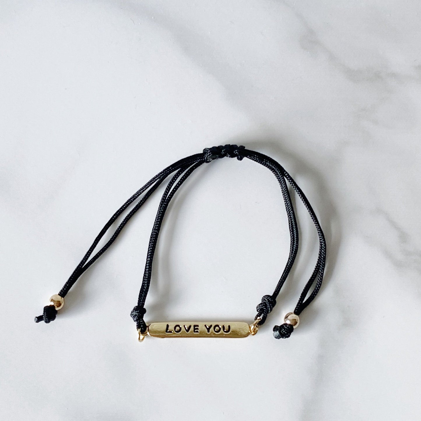 Black cotton cord bracelet, and "love you" gold-plated plaque, isvi boutique